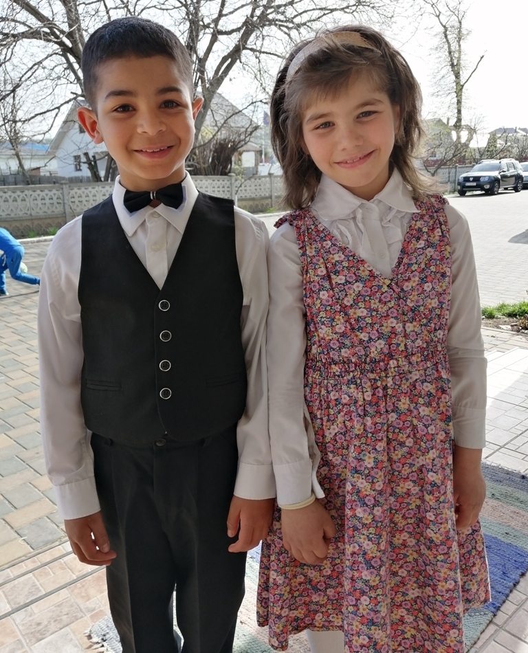 A boy and a girl in fine clothes